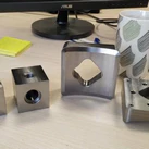 Custom CNC machined S235 steel bracket with precision square opening and mounting holes