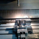 Complex 16MnCr5 steel housing during precision CNC milling on a 3-axis machining center